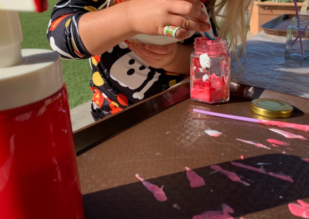 Child pumping paint to revisit red and create new hues