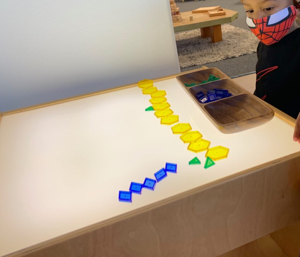 Child designing on light table 