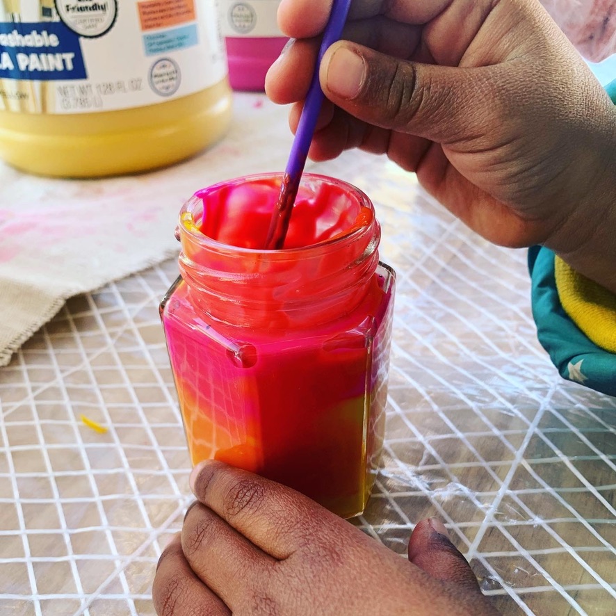 Child Mixing Colors for Emotion Paint