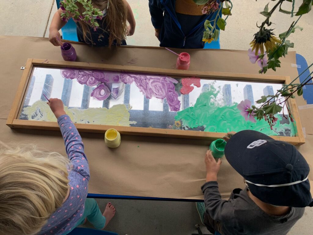 Children painting nature in a mirror